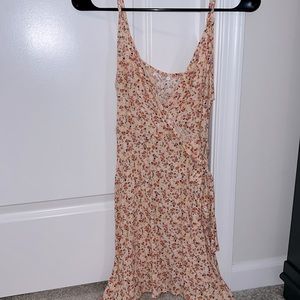 Spaghetti strap dress. Tie detailing on side. No zippers or buttons to close